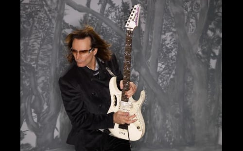 Steve Vai playing a white Ibanez Jem electric guitar