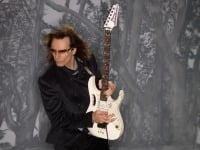 Steve Vai playing a white Ibanez Jem electric guitar