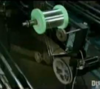 Close up of electric guitar string making machine in the D'Addario factory